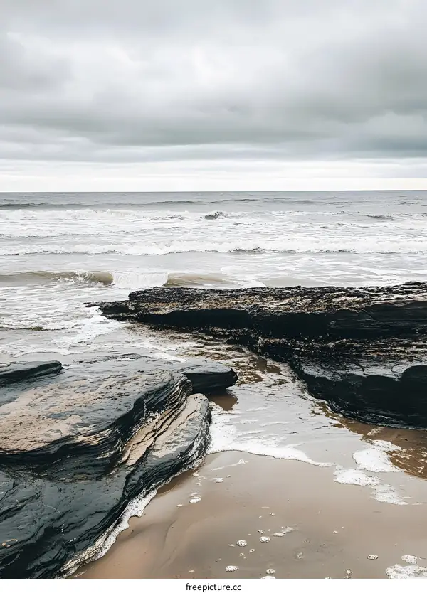 Sea Waves Crashing Against Rocks on a Sandy Beach