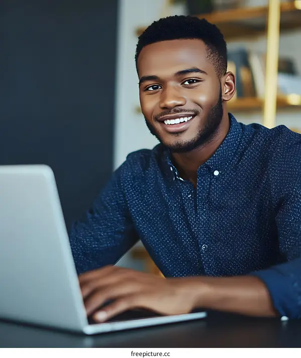 Smiling African American Businessman Working on Laptop
