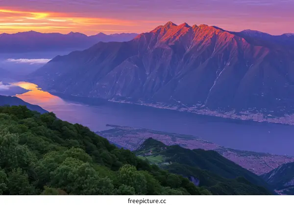 Scenic view of mountains and lake at sunset