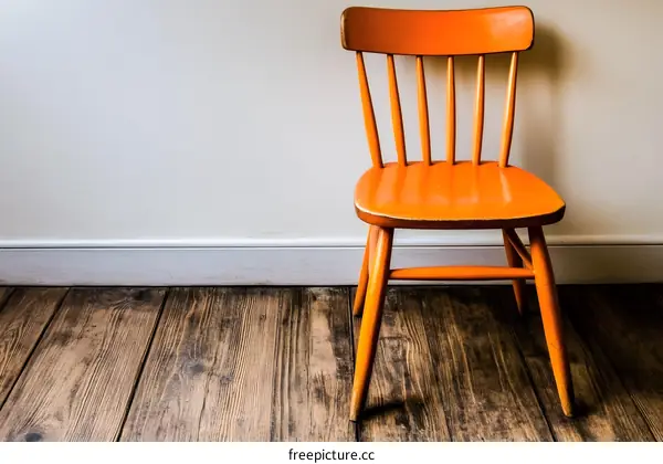 Orange Chair Against White Wall and Wooden Floor
