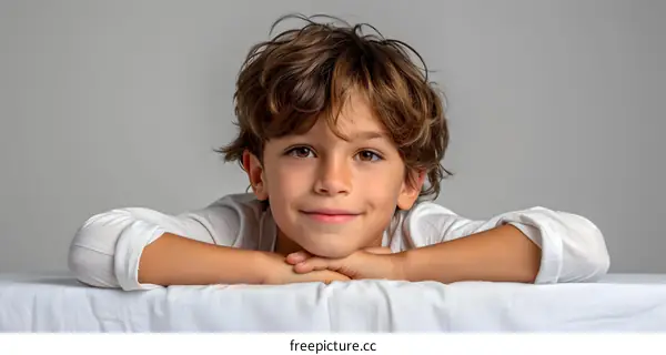 Portrait of a happy smiling boy with brown hair and brown eyes