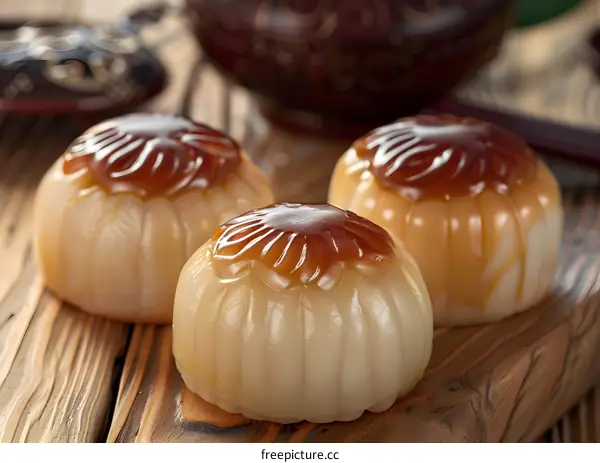 Closeup of Three Chinese Sweet Rice Cakes on Wooden Table