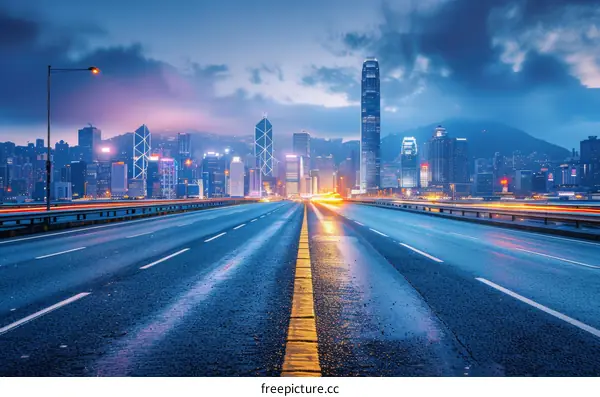 Hong Kong city night view with empty highway in the foreground