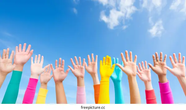 Colorful hands raised in the air