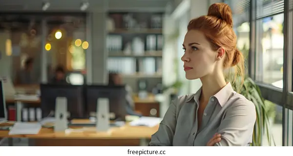 Redhead Woman Looking Out the Window in Office