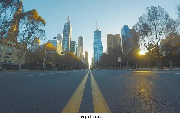 An empty road in the city with skyscrapers on the horizon