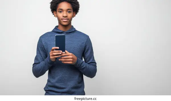 Young Black Teenager Holding Smartphone