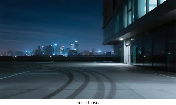 City rooftop at night with building and urban skyline visible