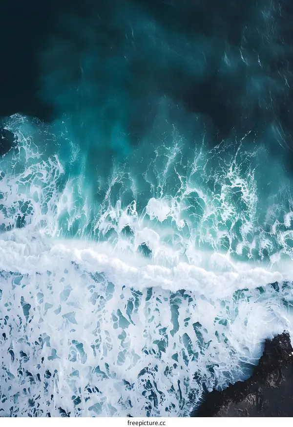 Aerial View of Ocean Waves Breaking on a Rocky Shoreline