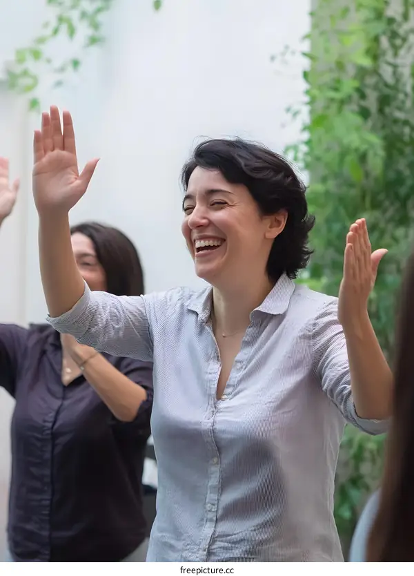 Happy Woman Raising Her Hand in a Group Setting