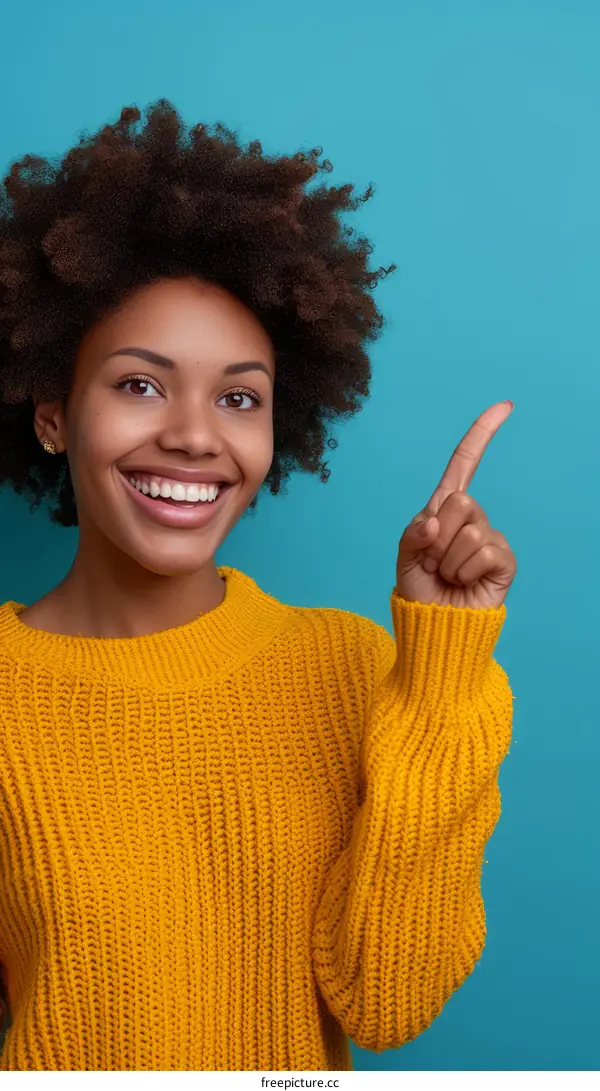 Cheerful young woman with toothy smile pointing away