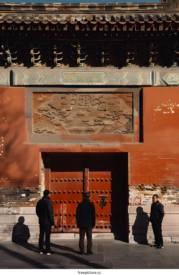 Ancient Chinese Architecture With Three Men Standing In Front Of An Ornate Door