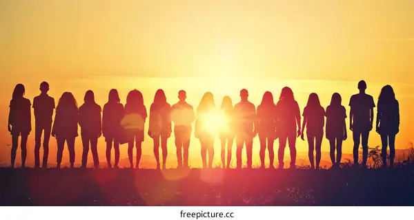 Silhouettes of People Standing in a Row at Sunset