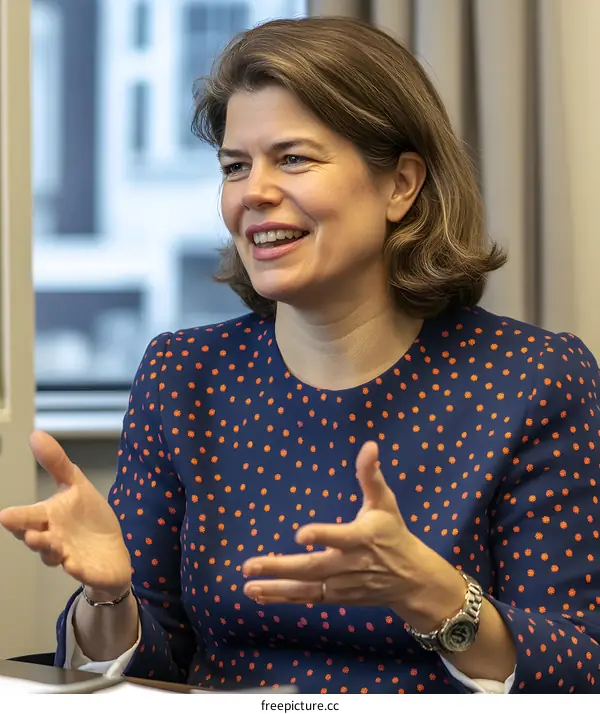 Smiling Woman in Polka Dot Blouse Talking with Gestures