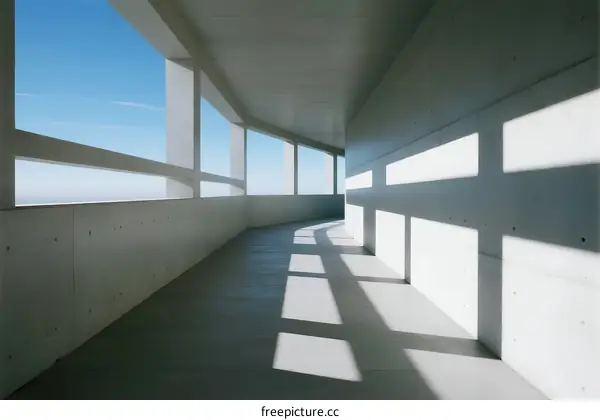 A Long White Corridor with Large Windows and Sunlight