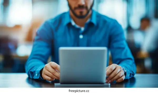Business Person Working on Laptop in Modern Office
