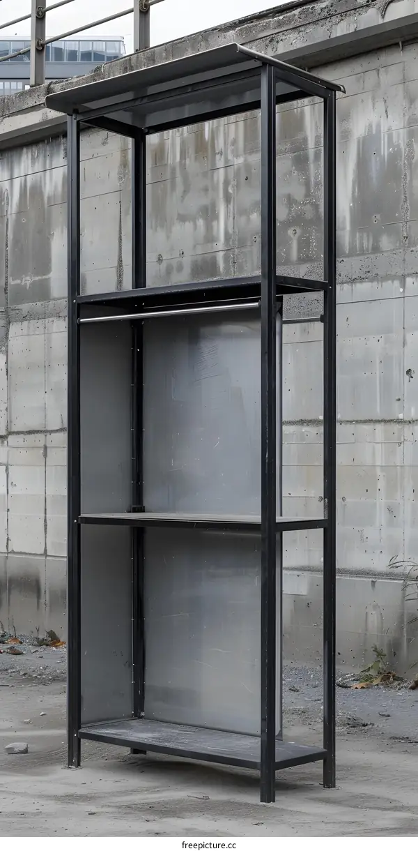 Metal Shelving Unit with Roof Against Concrete Wall