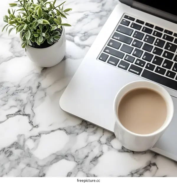 White Marble Desktop with Coffee, Laptop and Plant