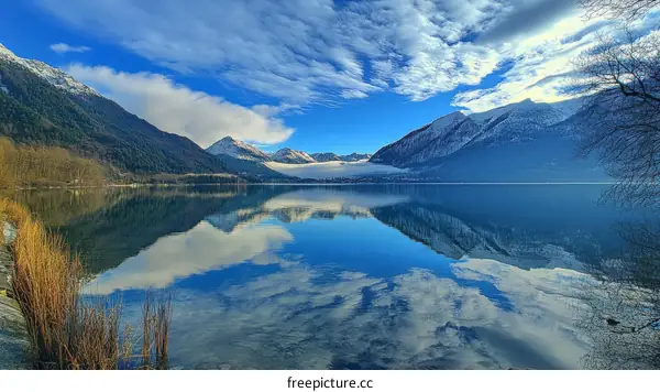 Serene Mountain Lake Reflection with Clouds