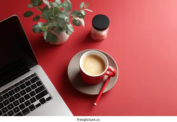 Red Desk Setup with Coffee and Laptop