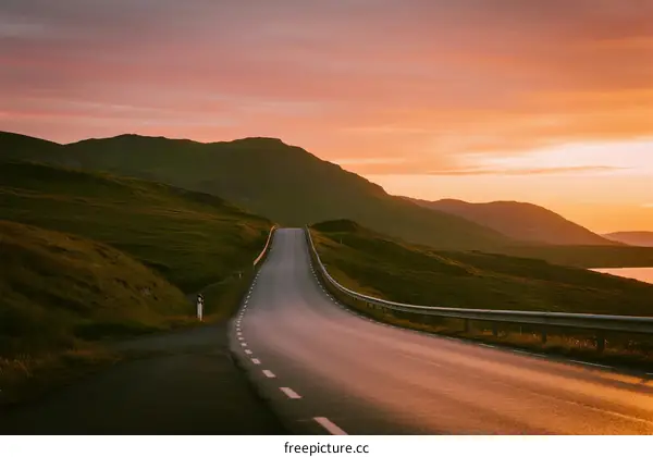 Scenic road at sunset with rolling hills and clear sky