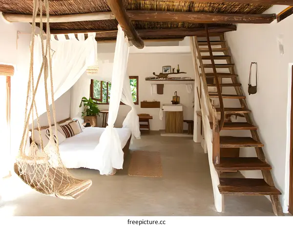 Rustic Wooden Staircase Leading Up To A White Canopy Bed