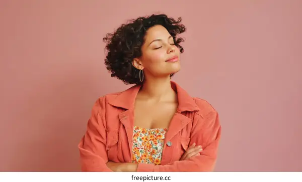 Stylish Woman in Coral Jacket Against Pink Background