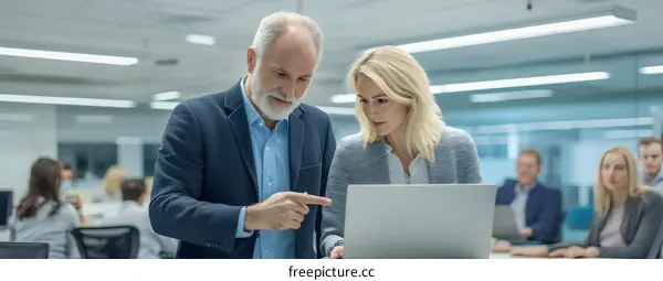 Business Colleagues Collaborating on Laptop in Modern Office