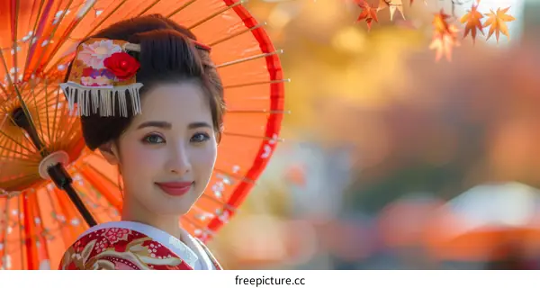 Portrait of a Japanese woman in traditional kimono with red umbrella