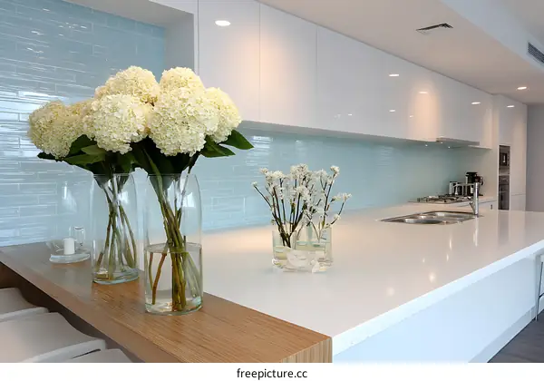 Modern Kitchen with Light Blue Tiles and White Cabinets