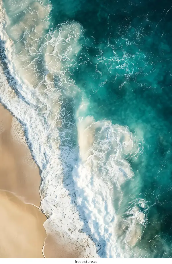 Aerial View of Turquoise Ocean Waves Crashing on Sandy Beach