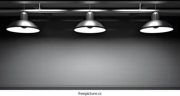 Three Hanging Lights On A Black Wall