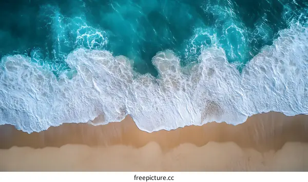 Aerial View of Ocean Waves Crashing on Sandy Beach