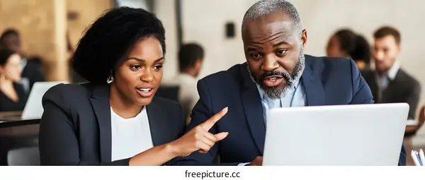 Two Business Professionals Working on a Laptop Together