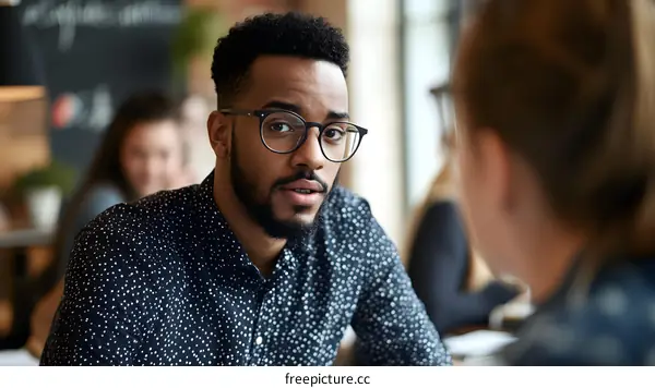 African American Man with Beard and Glasses Looking at Woman in Coffee Shop