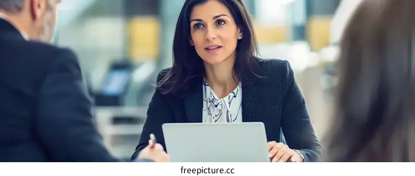 Businesswoman Discussing Project with Colleagues in Office