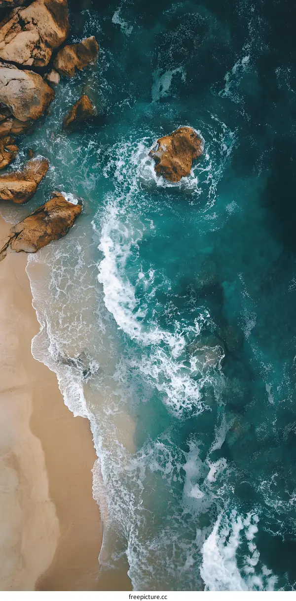Aerial View of Turquoise Ocean Waves Crashing on Sandy Beach