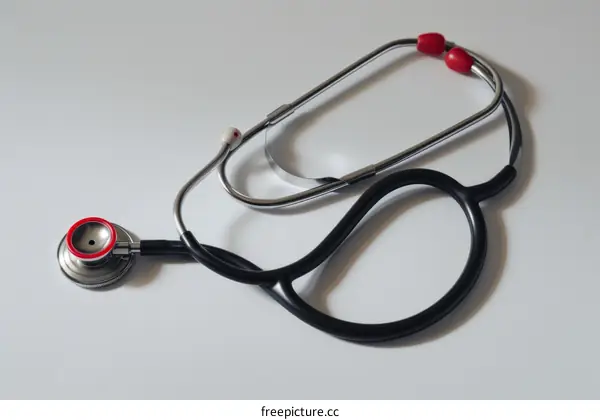 A black stethoscope with red accents on a white background