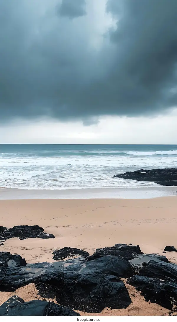 Stormy Beach With Dark Rocks And Sand