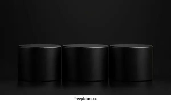 Three Black Cylindrical Podiums on Black Background