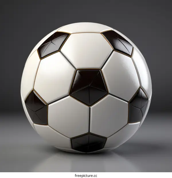 Black and white soccer ball with gold accents on a gray background
