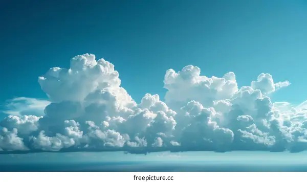 Cumulus cloudscape with blue sky and ocean below