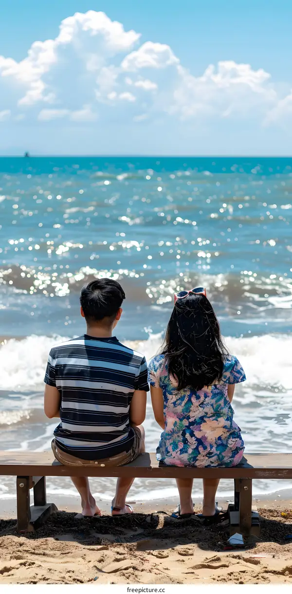 Couple Sitting on a Bench Facing the Sea