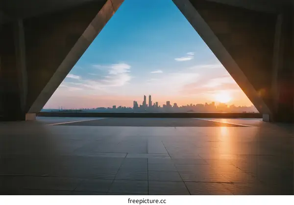 A triangular frame revealing a cityscape at sunrise with clear sky