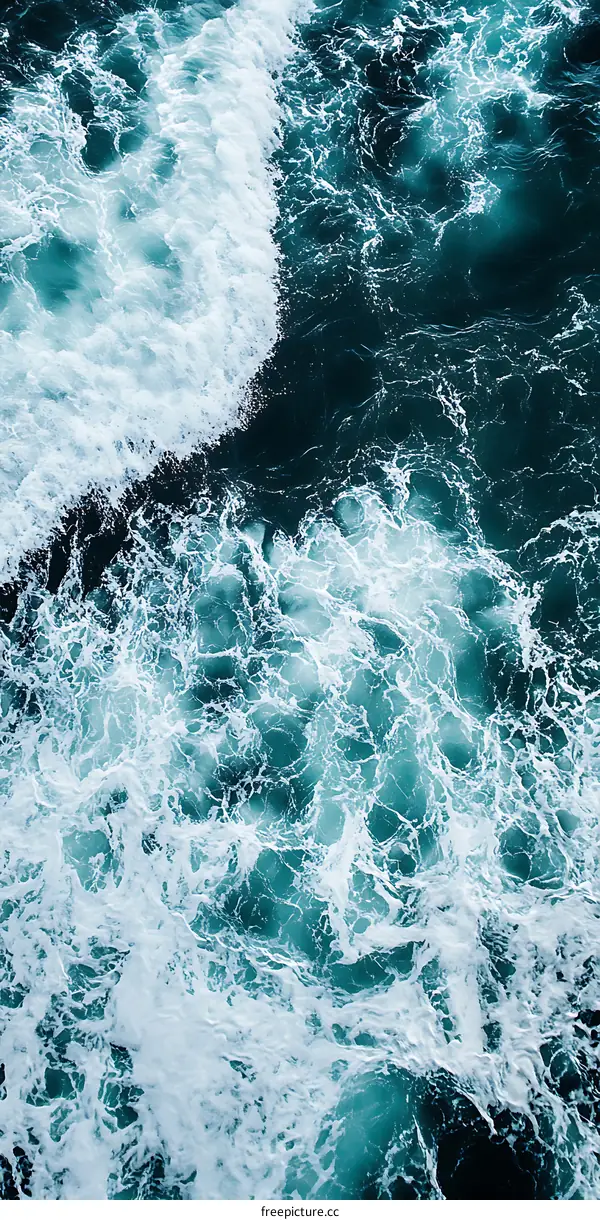 Aerial View of Ocean Waves with White Foam