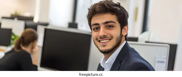 Smiling Businessman in Modern Office Workplace