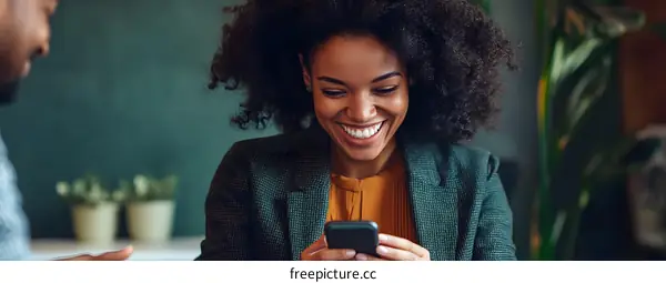 Happy Woman Looking At Her Smartphone