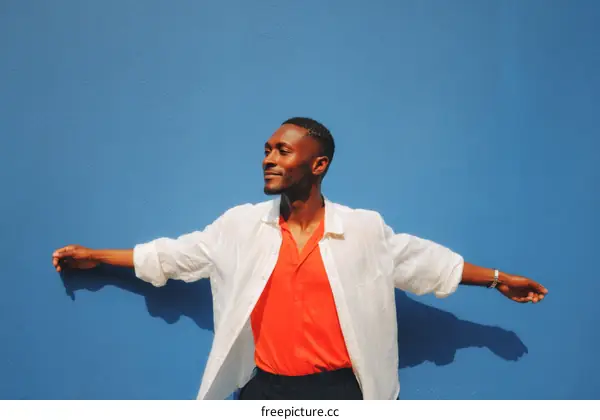 Happy African Man Outdoor Portrait Against Blue Wall