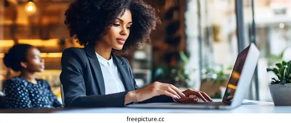 African American Businesswoman Working on Laptop in Office