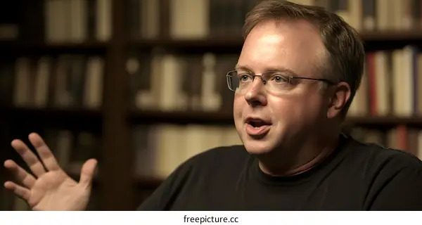 Man with Glasses Talking in a Library